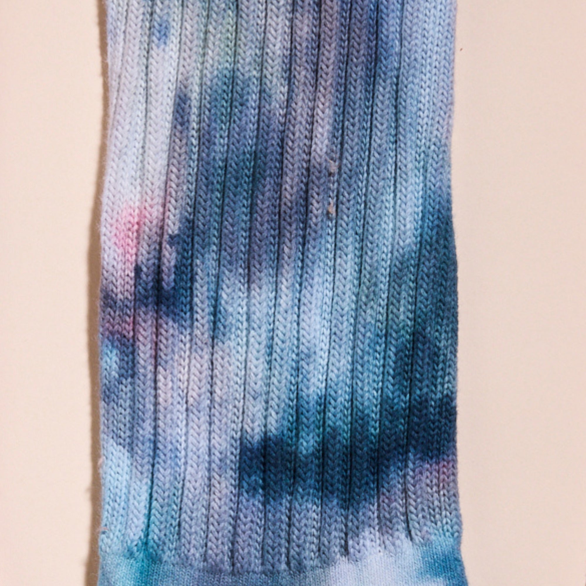 a closeup on the hand-dyed crew sock's Lake Effect color.