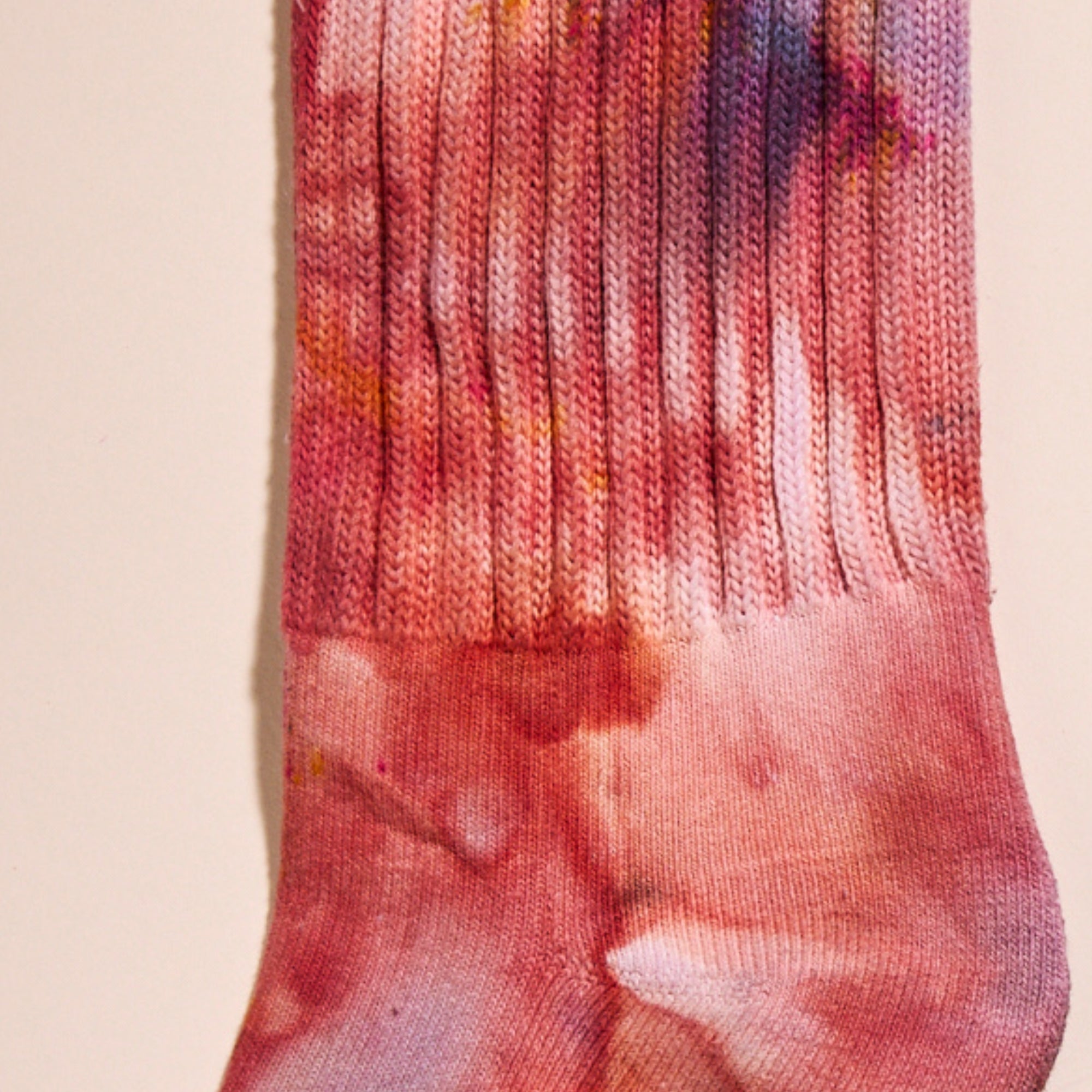 A closeup on Goldy Way's hand-dyed crew sock in the Solstice color.