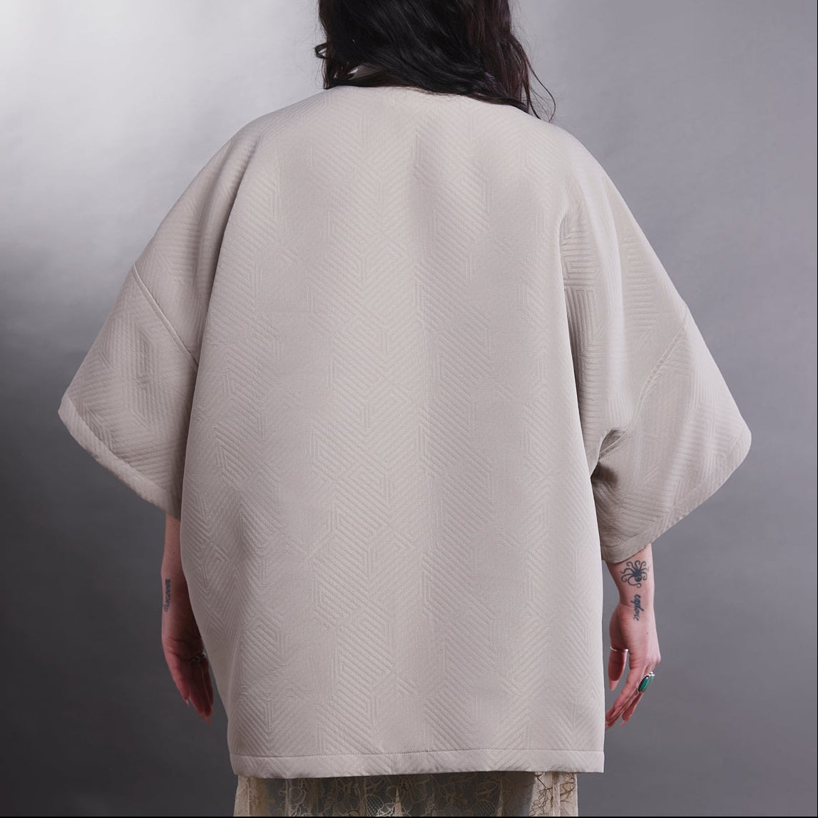 Model wearing a beige ARW jacket.