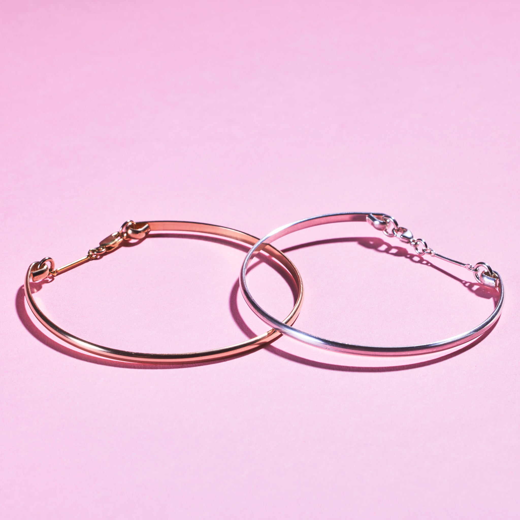 Two of Peg's Hardware's Peg's Bangles. A gold version is on the left, a silver version on the right. 