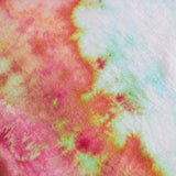 A close-up of a tie-dye fabric texture featuring a blend of pink, orange, yellow, and mint green on a white base.