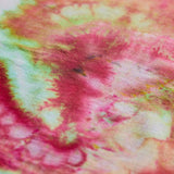 A close-up of a tie-dye fabric with a marbled pattern in vibrant pink, soft green, and cream white.