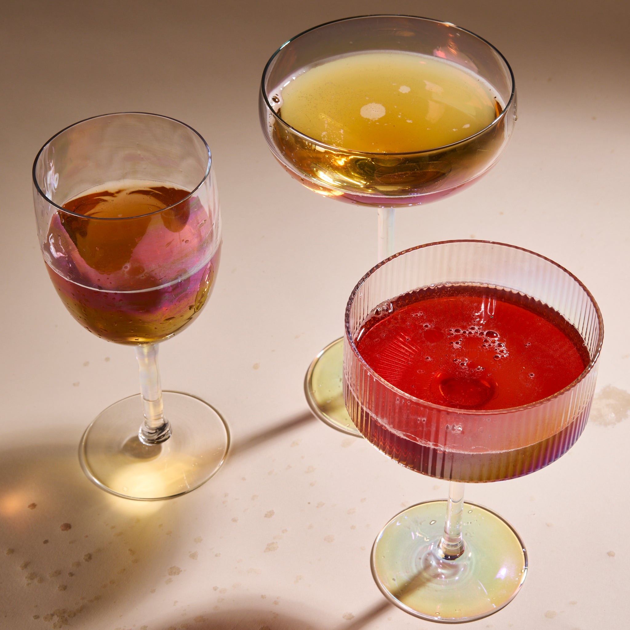 Cup of Communitea's tea infused simple syrups, each poured into cocktail glasses and mixed with another beverage. 