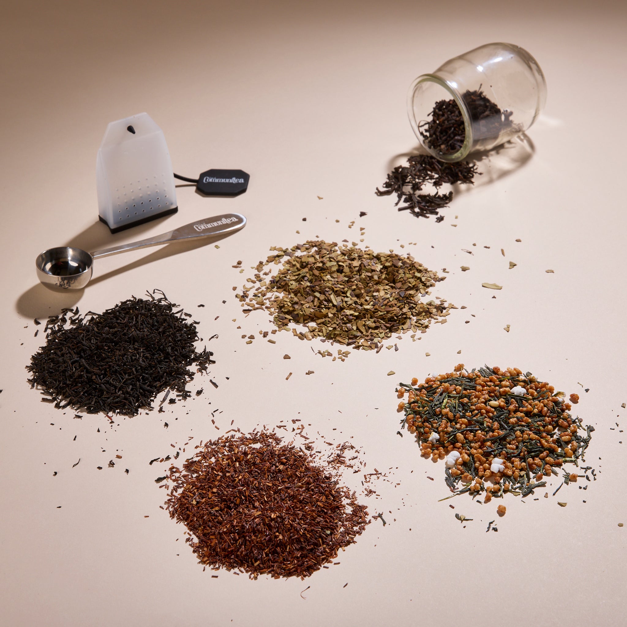 Cup of Communitea's around the world tea sampler set. Tea blends are accompanied by a small clear glass, spoon and reusable tea sachet.