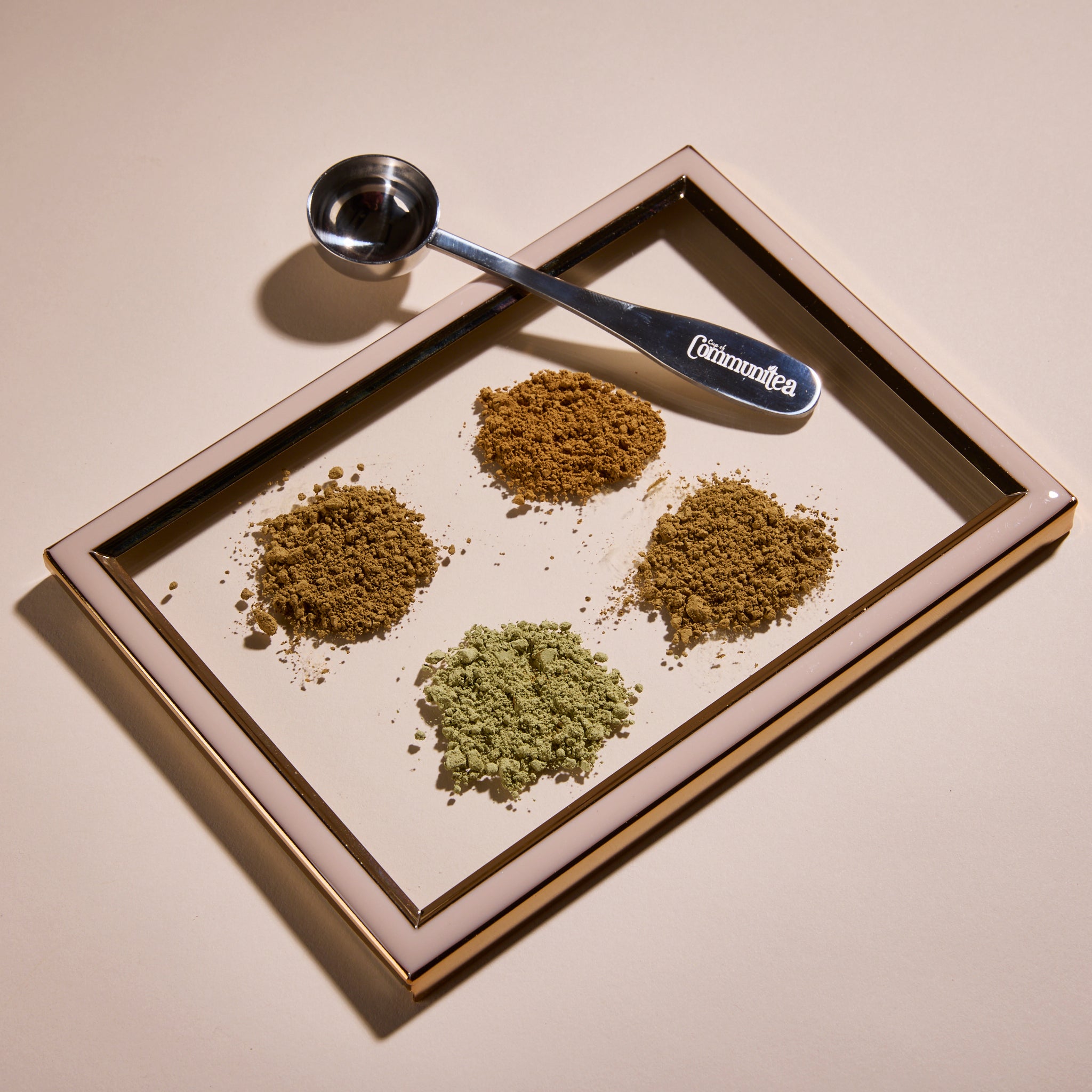 Cup of Communitea's tea latte set, with an accompanying Cup of Communitea spoon.