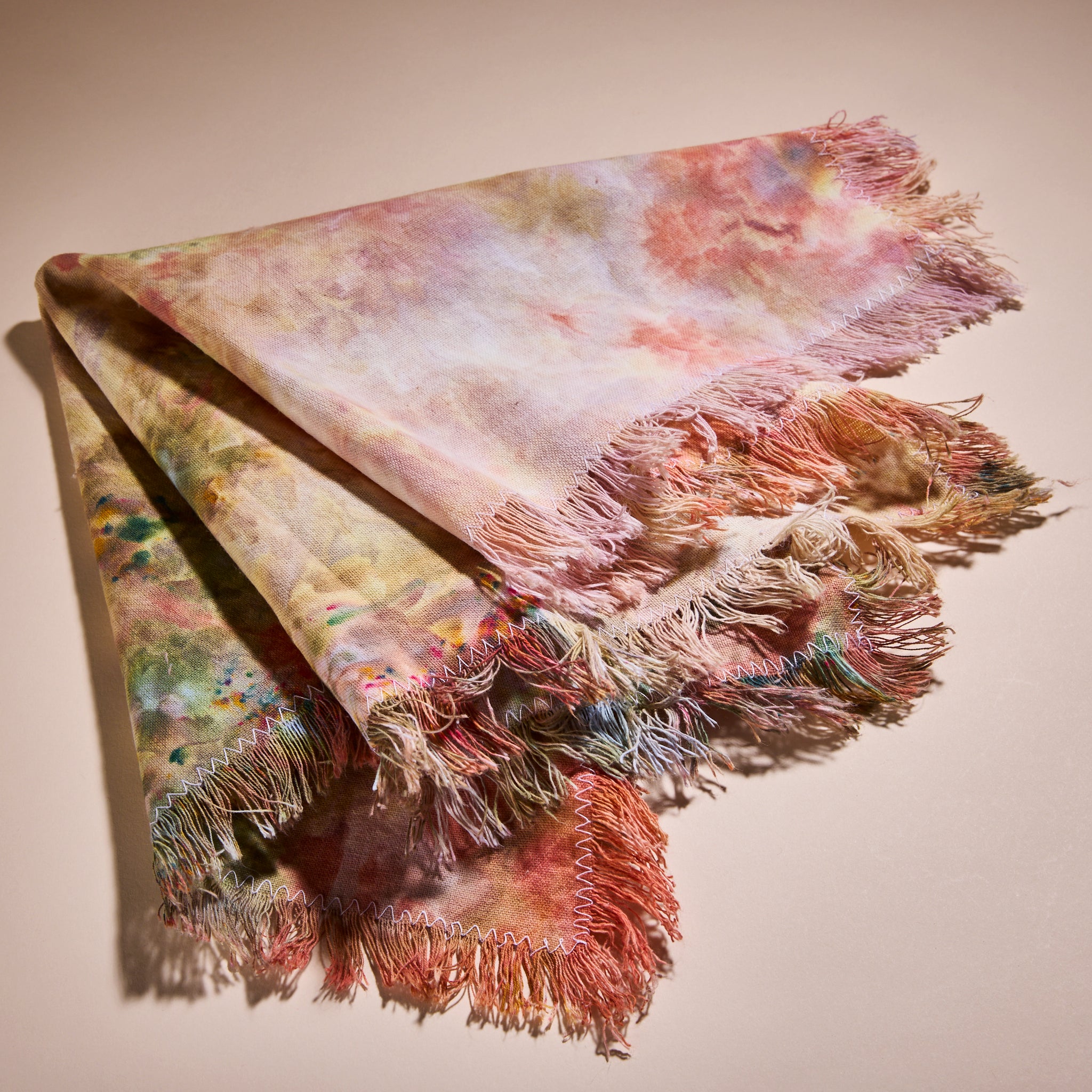 Goldy Way's hand-dyed linen table runner, folded and fanned out.