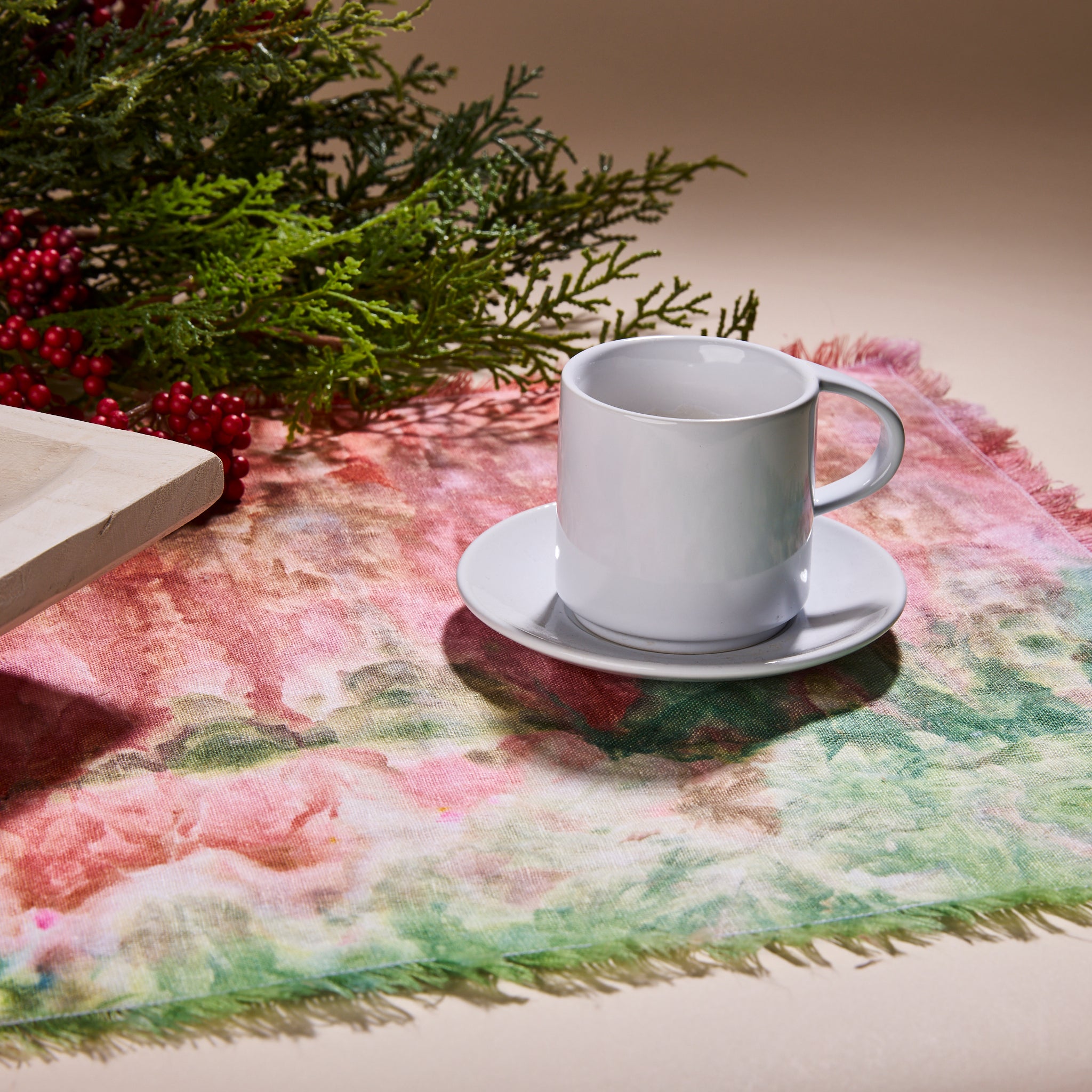 Goldy Way's hand-dyed linen table runner, with a coffee cup and saucer on top of it.