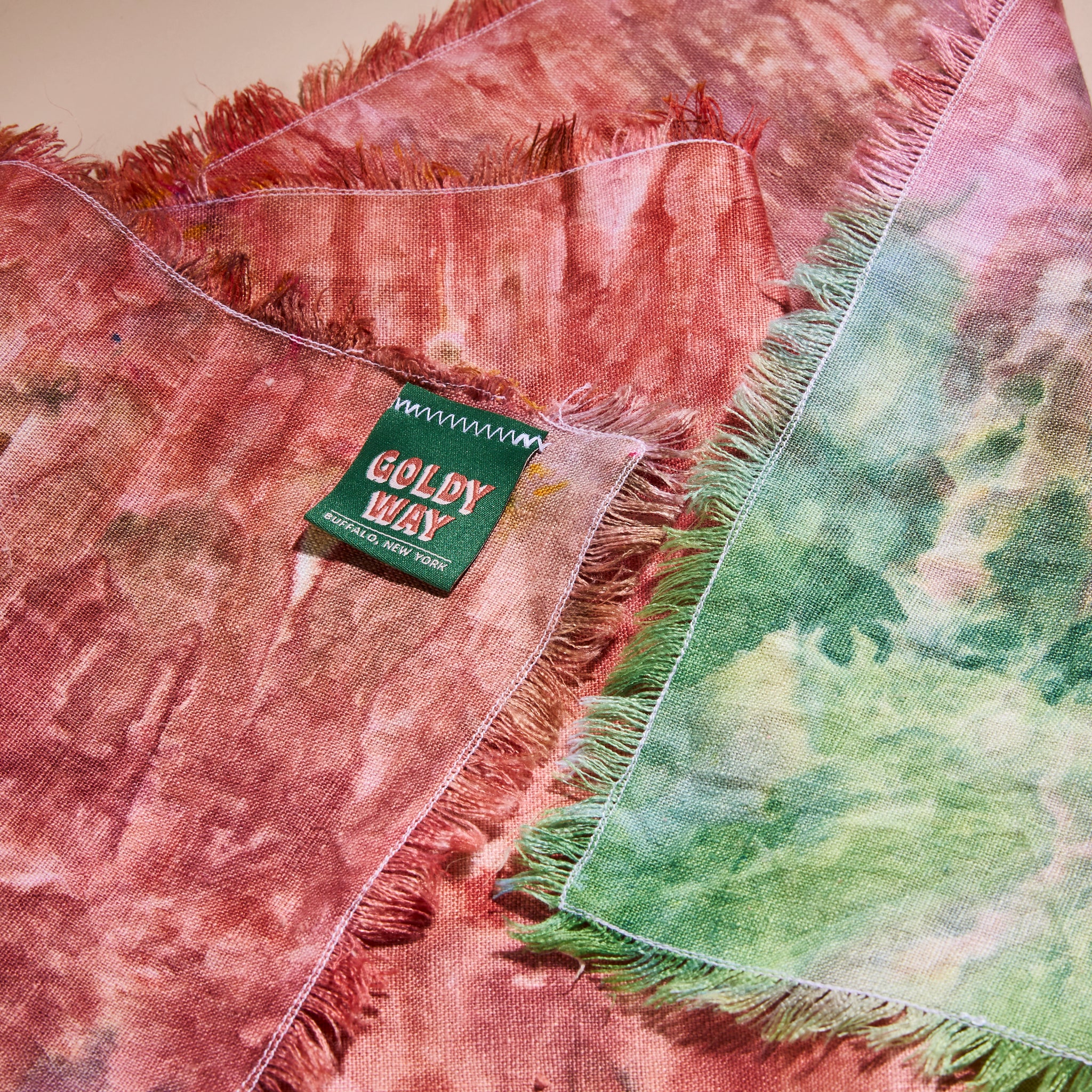 A closeup on Goldy Way's hand-dyed linen table runner, with a Goldy Way label stitched on the back.