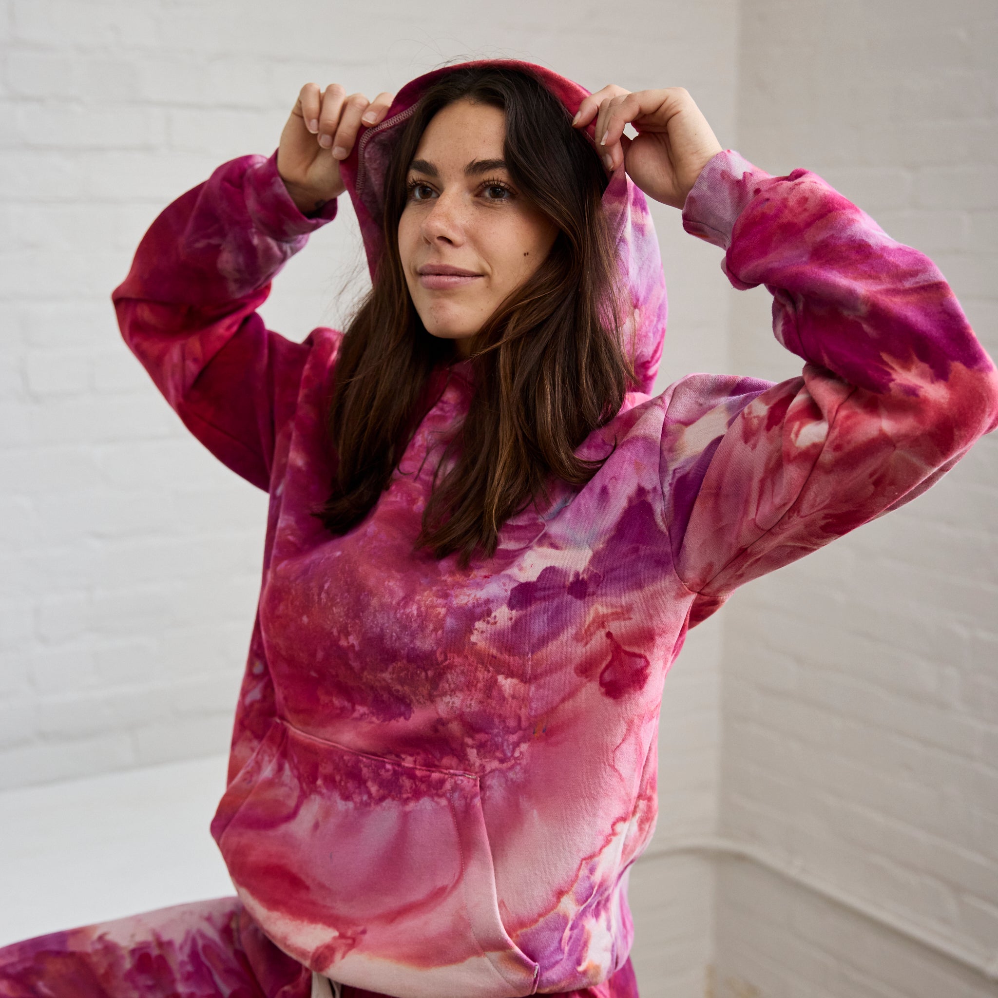 Goldy Way's ice-dyed unisex sweatsuit in the Winterberry color, worn by a model.