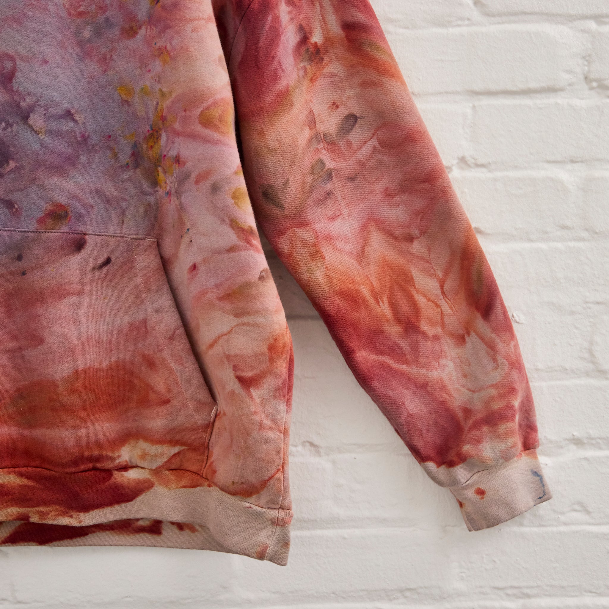 A closeup of Goldy Way's ice-dyed unisex sweatshirt, featuring a sleeve in the Solstice color.