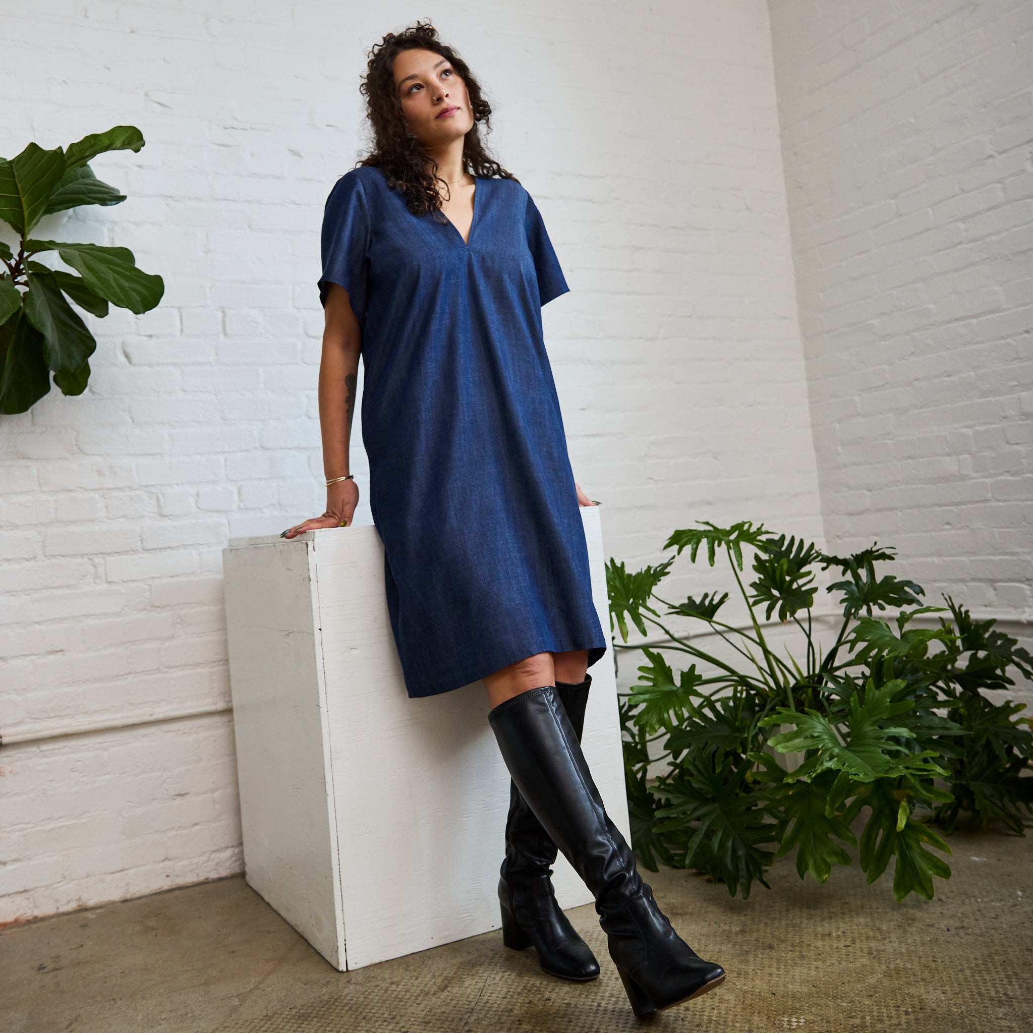 the denim version of ARW's deep V block dress, being worn on a model.
