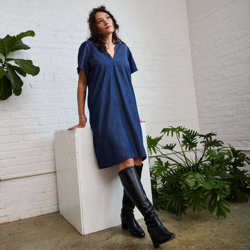 the denim version of ARW's deep V block dress, being worn on a model.
