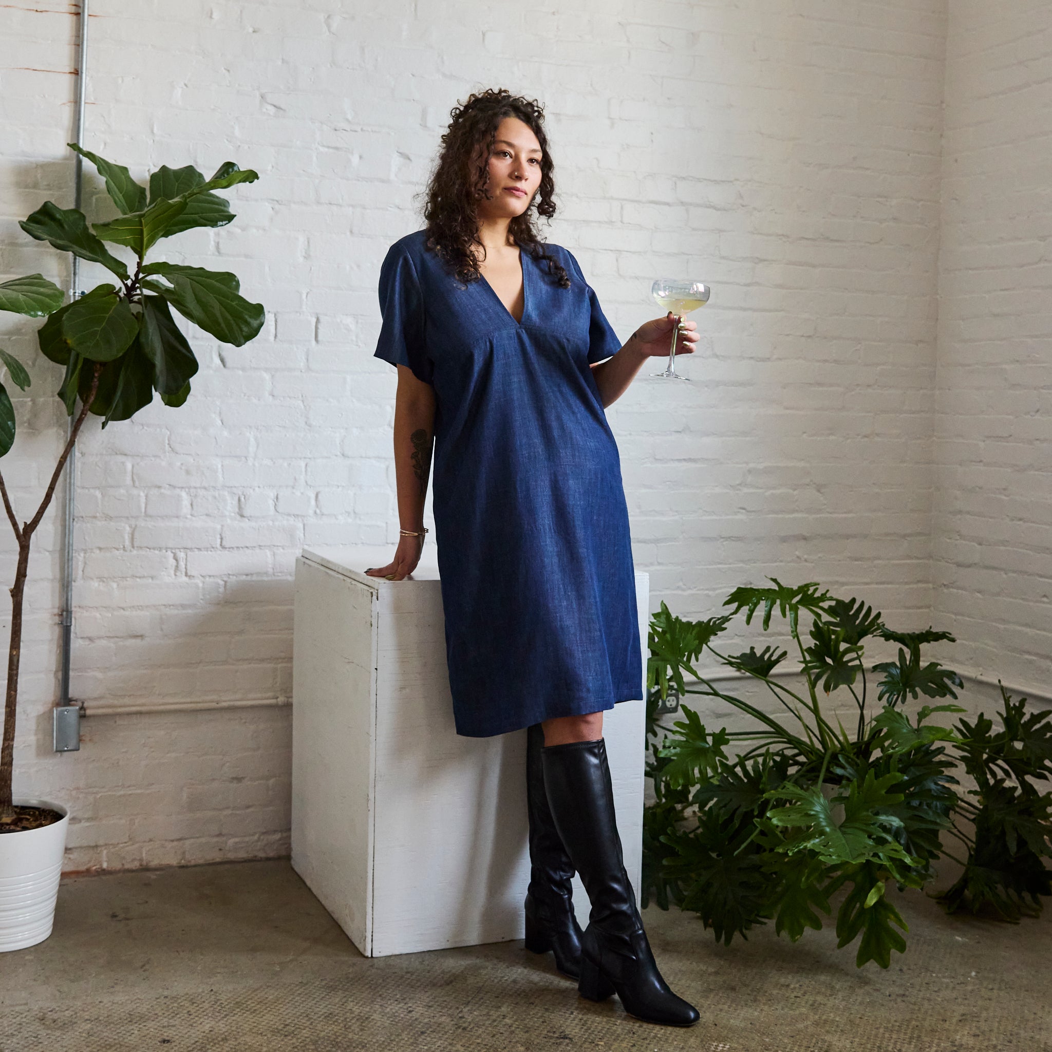the denim version of ARW's deep V block dress, being worn on a model.