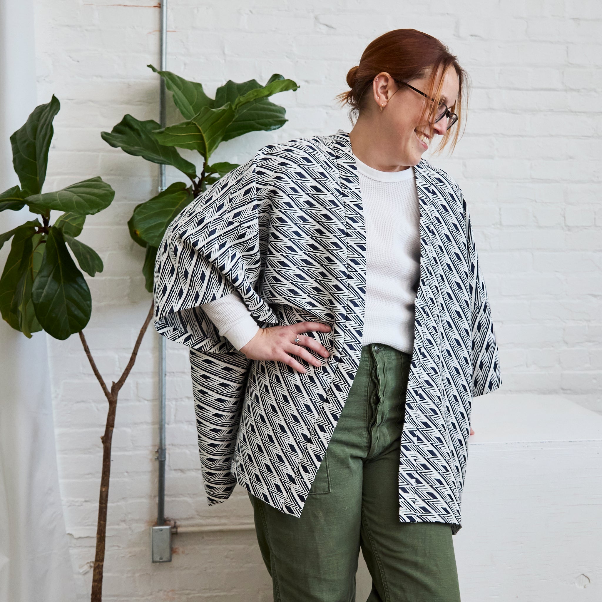 the navy and white version of ARW's open layering jacket, being worn on a model.