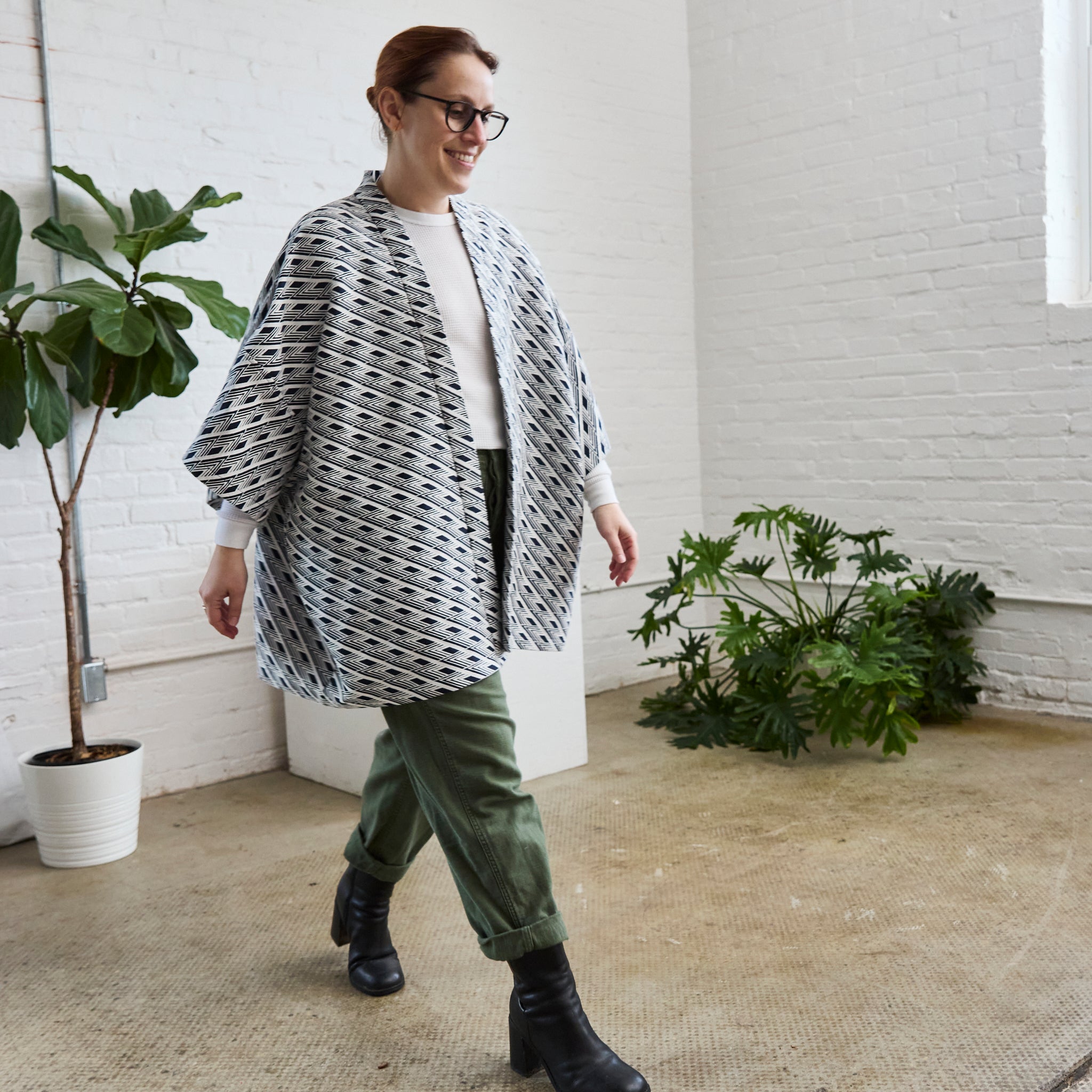 the navy and white version of ARW's open layering jacket, being worn on a model.