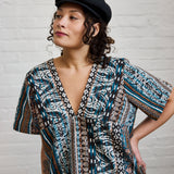 A closeup of ARW's deep V block dress, in the pattern version as worn on a model.