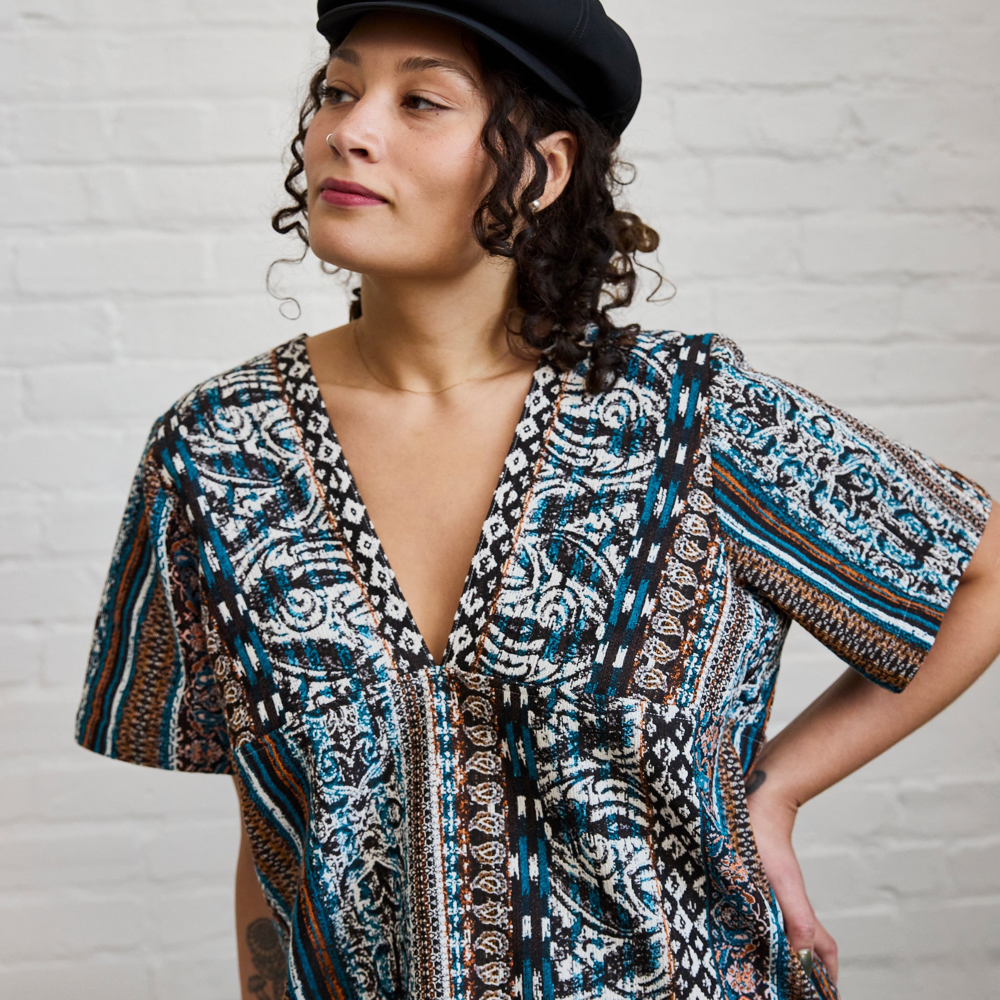 A closeup of ARW's deep V block dress, in the pattern version as worn on a model.