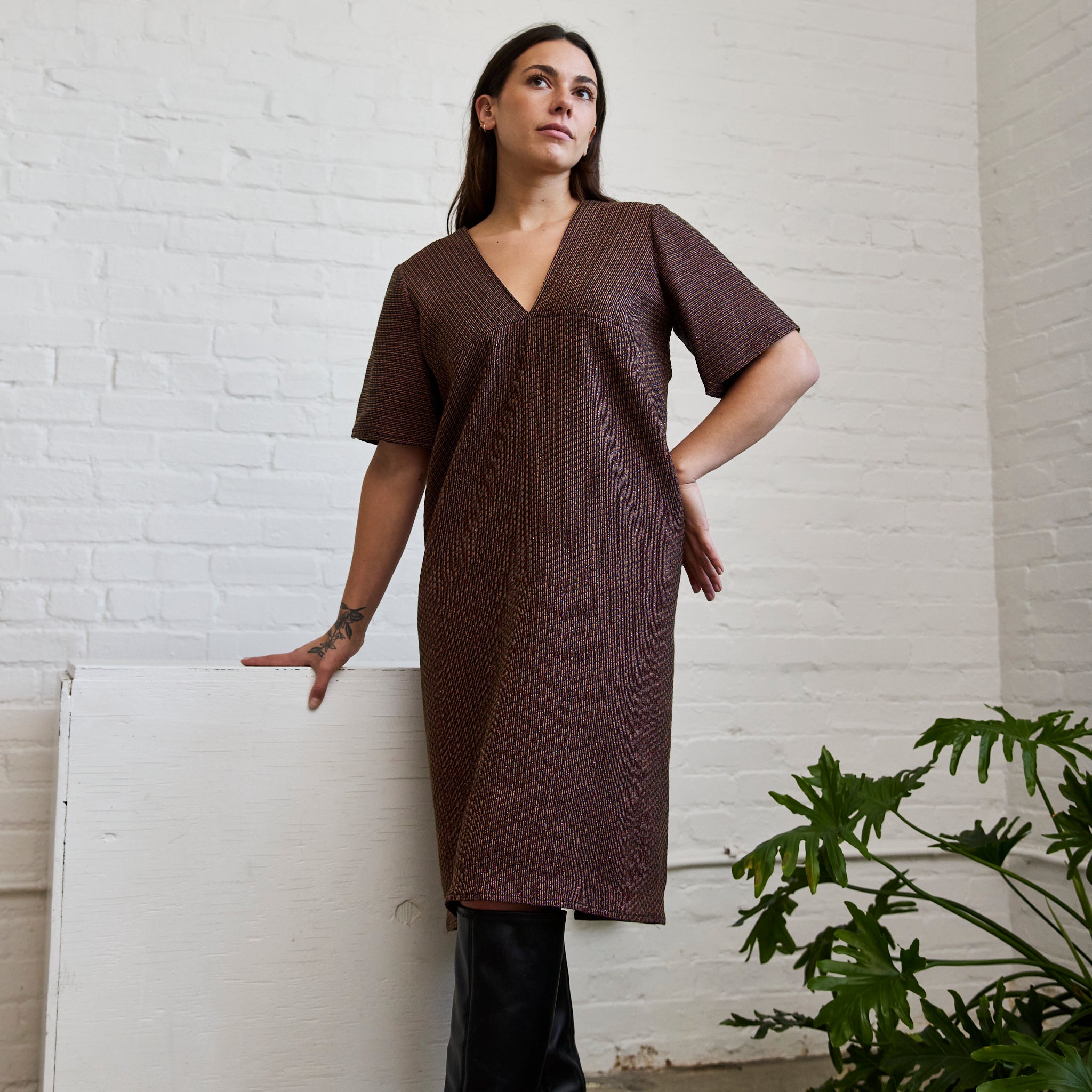 the metallic jacquard version of ARW's deep V block dress, being worn on a model.