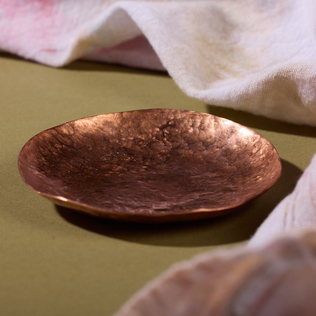 A hammered bronze trinket tray
