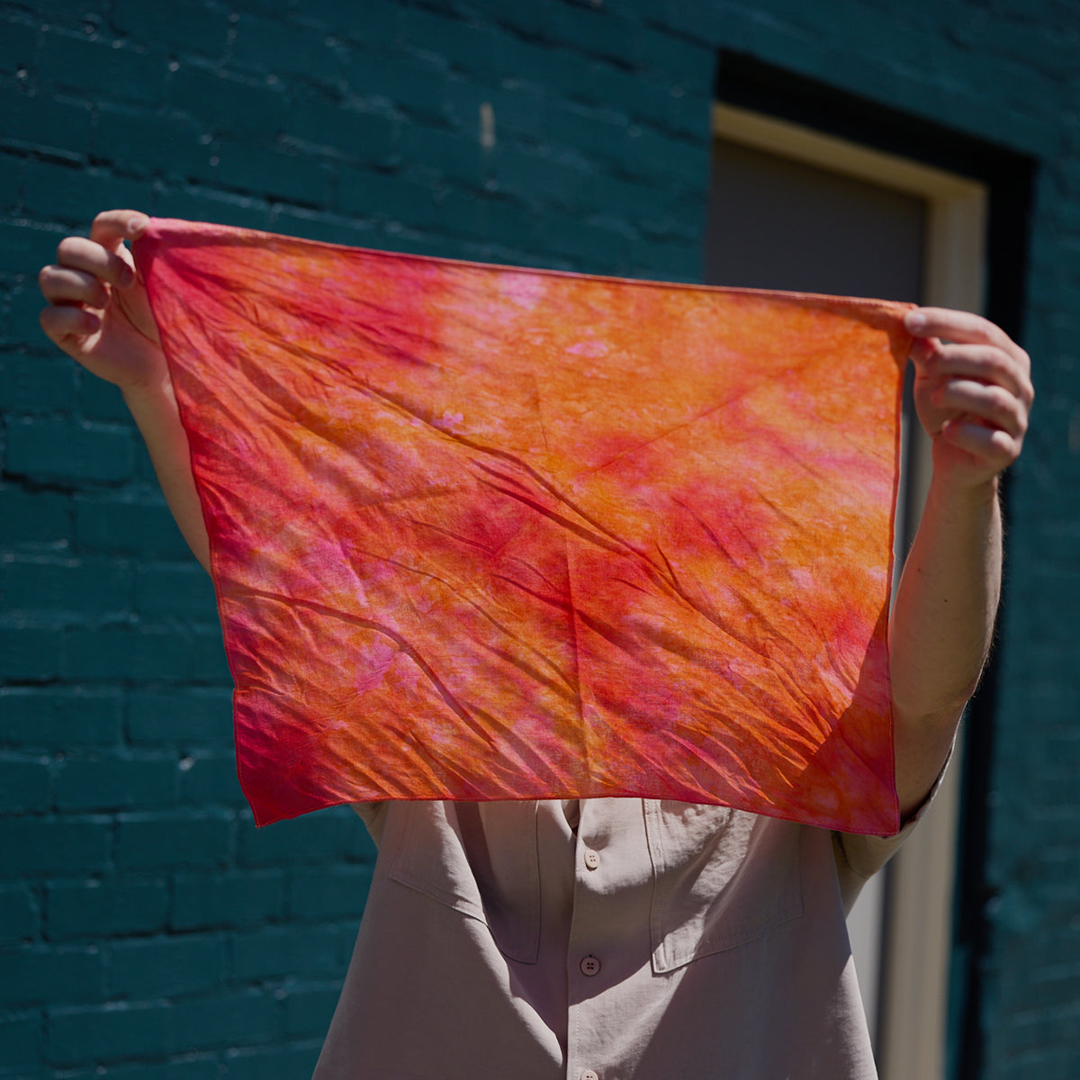 An orange ice-dyed bandana.