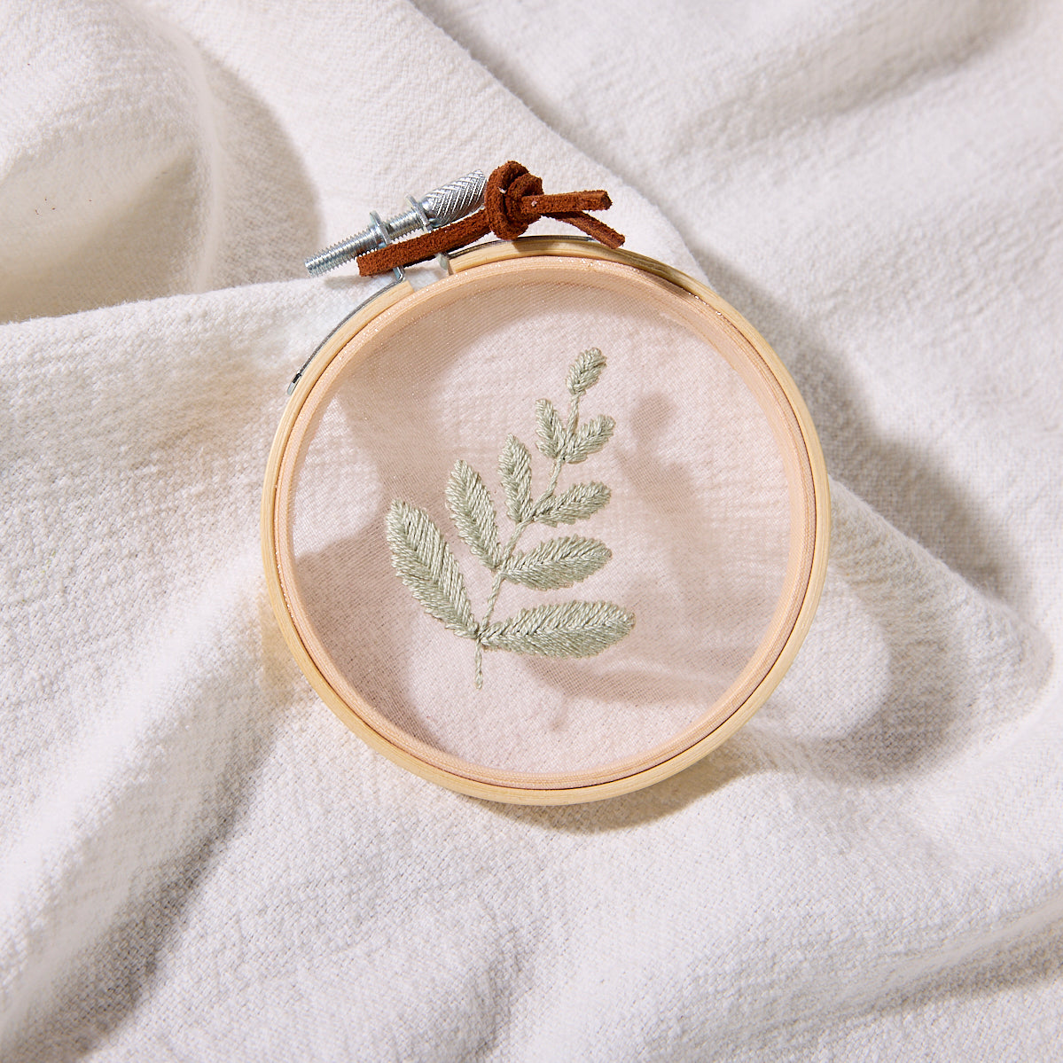 hand-embroidered fern hoop art